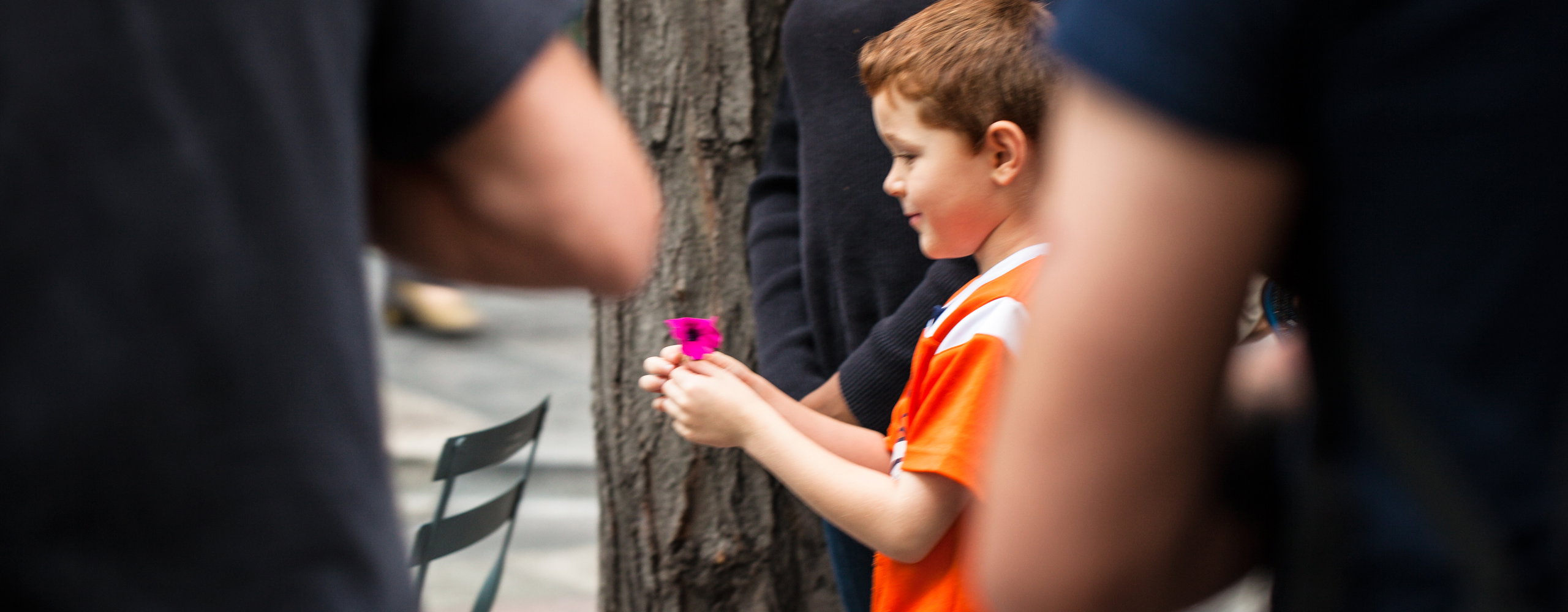 Child holding a flower and smiling