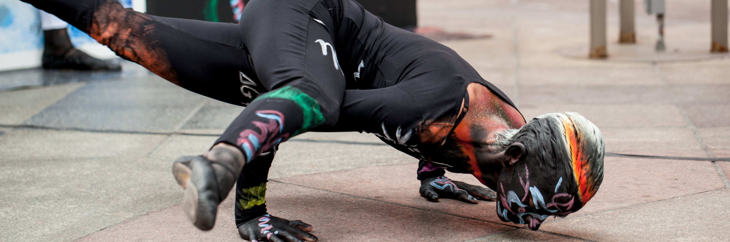 Engineering dancer with hands above head in excitement