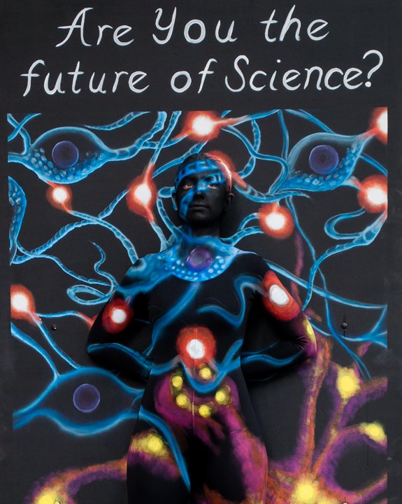 Painted dancer blending into the 'Are you the future of Science?' panel