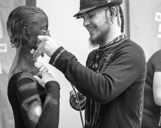 Black and white photo of the dancer getting painted